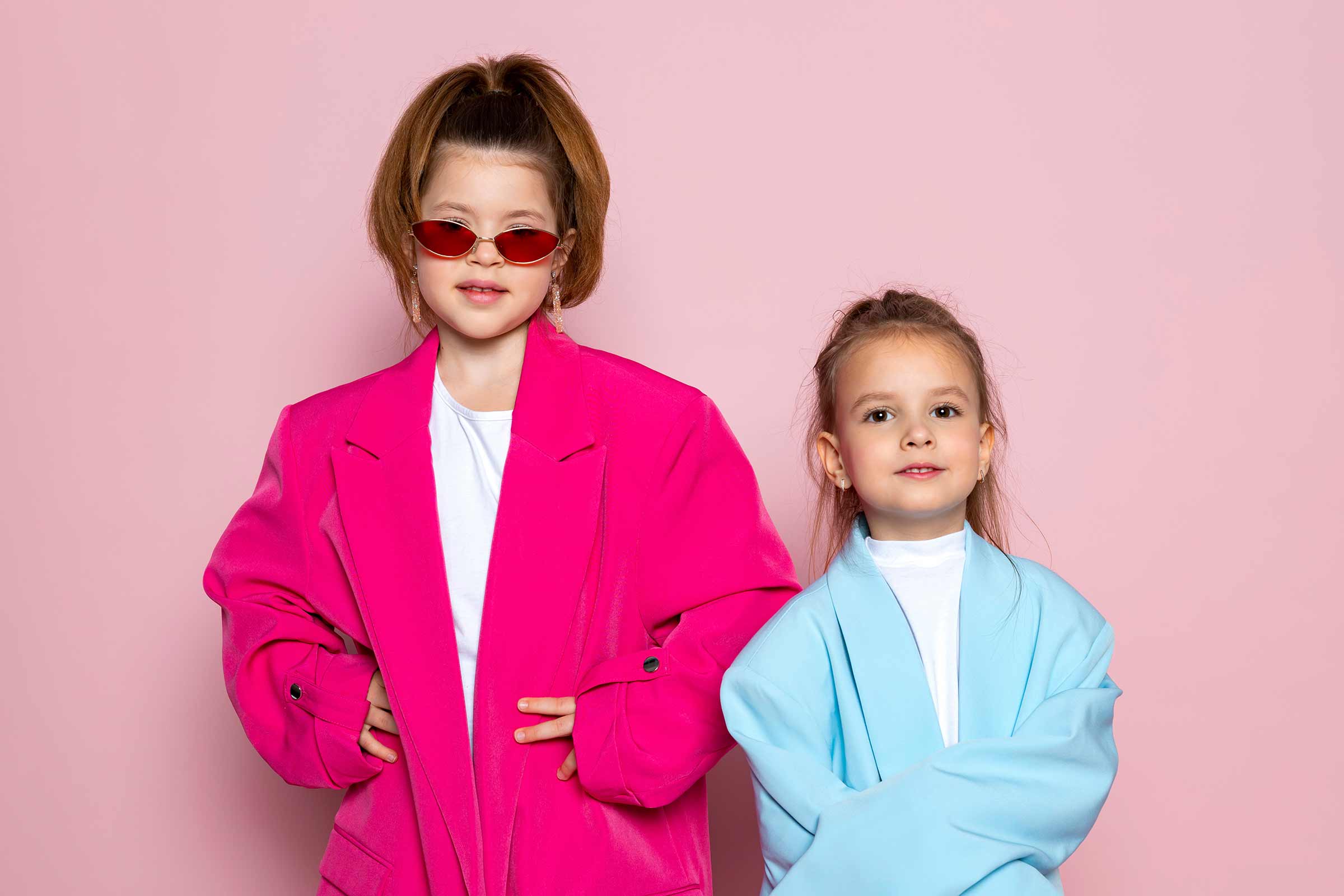 Two little girls playing dress-up