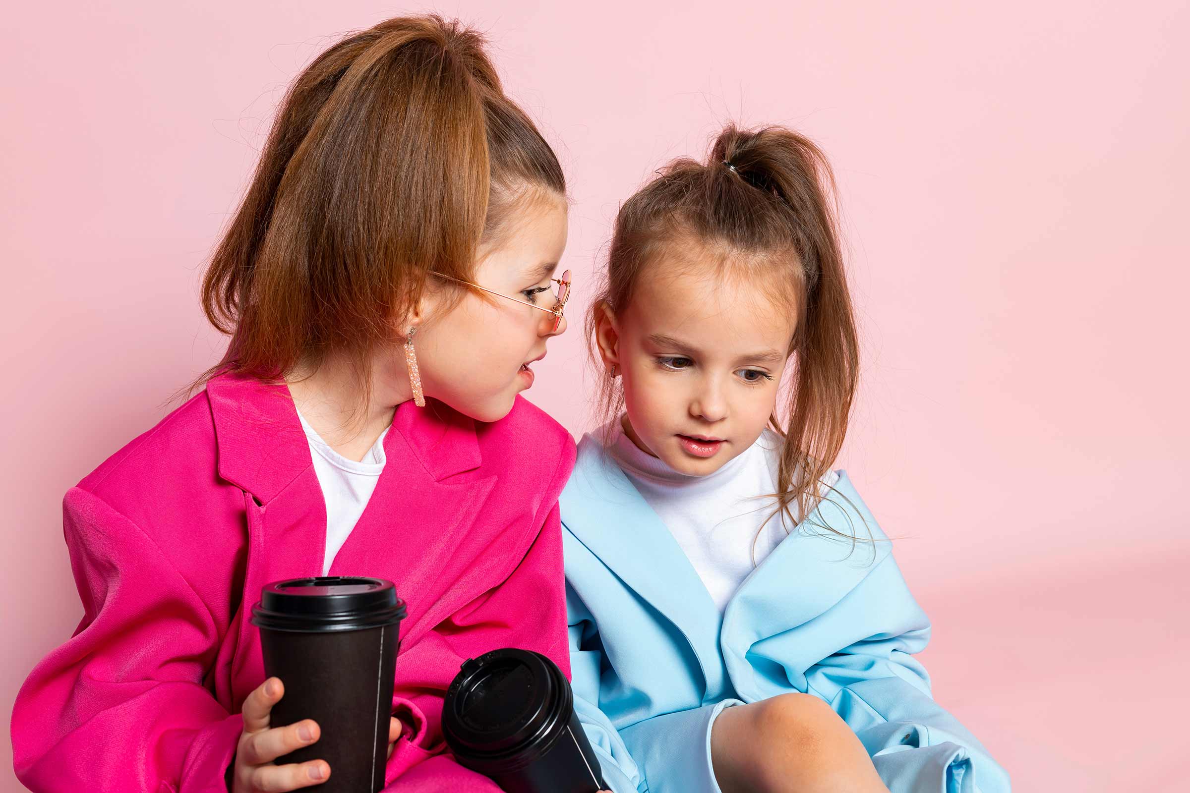 Two little girls playing dress-up